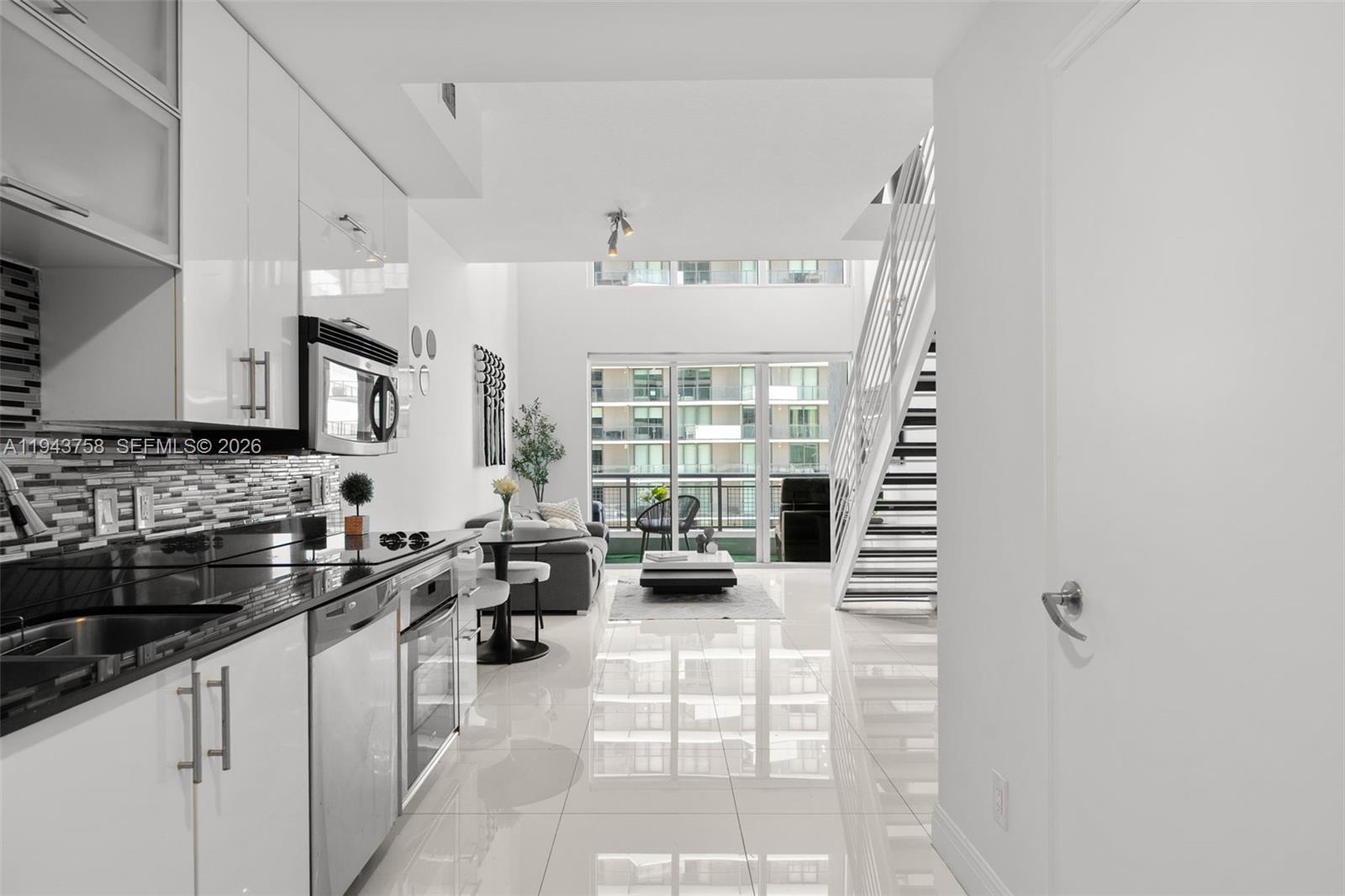 60 Southwest 13th Street, Unit 2812 Miami, FL 33130 - Photo 12 of 66 a kitchen with stainless steel appliances kitchen island granite countertop a sink and cabinets