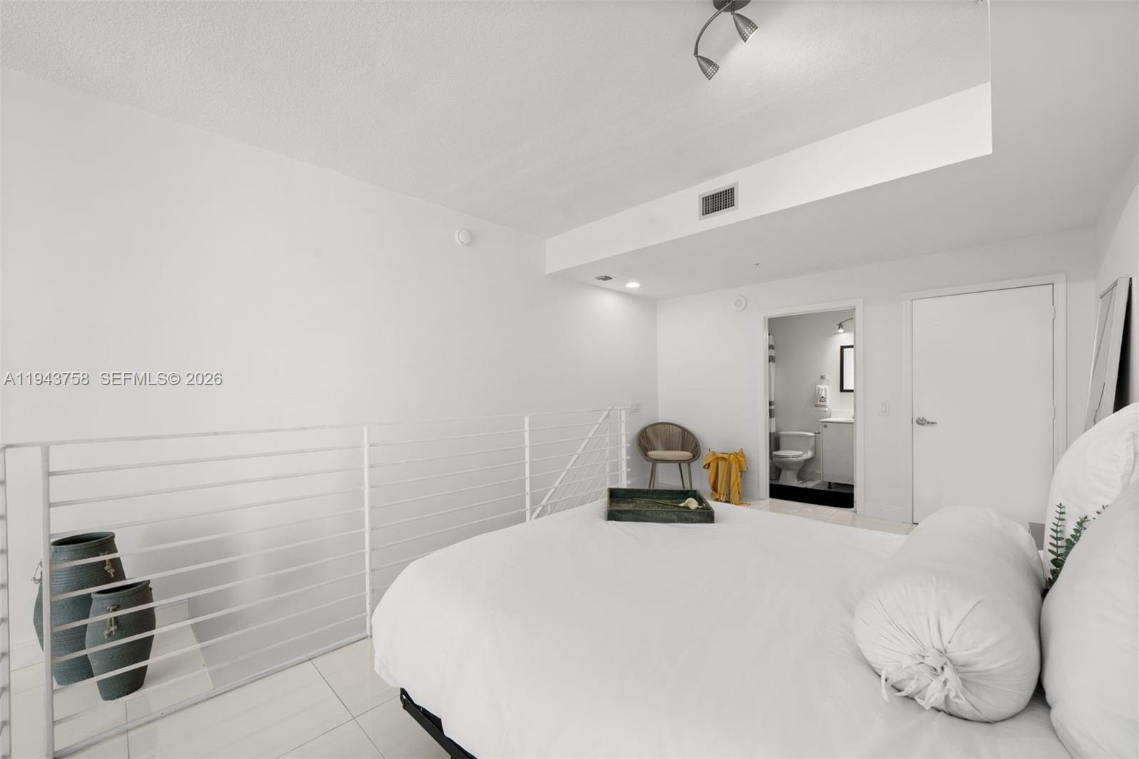 60 Southwest 13th Street, Unit 2812 Miami, FL 33130 - Photo 23 of 66 a bedroom with a bed and a cabinets