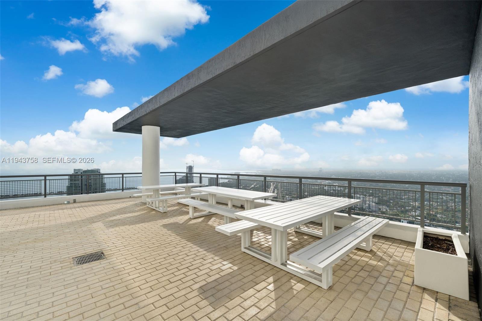 60 Southwest 13th Street, Unit 2812 Miami, FL 33130 - Photo 28 of 66 a terrace with a table and chairs