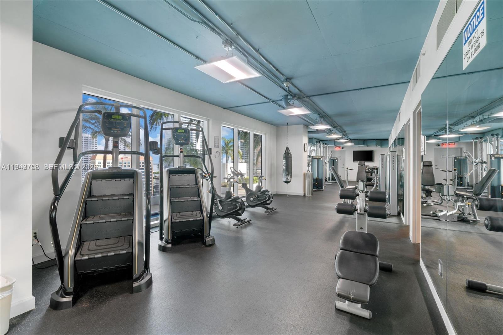 60 Southwest 13th Street, Unit 2812 Miami, FL 33130 - Photo 35 of 66 a view of a livingroom with furniture and a gym