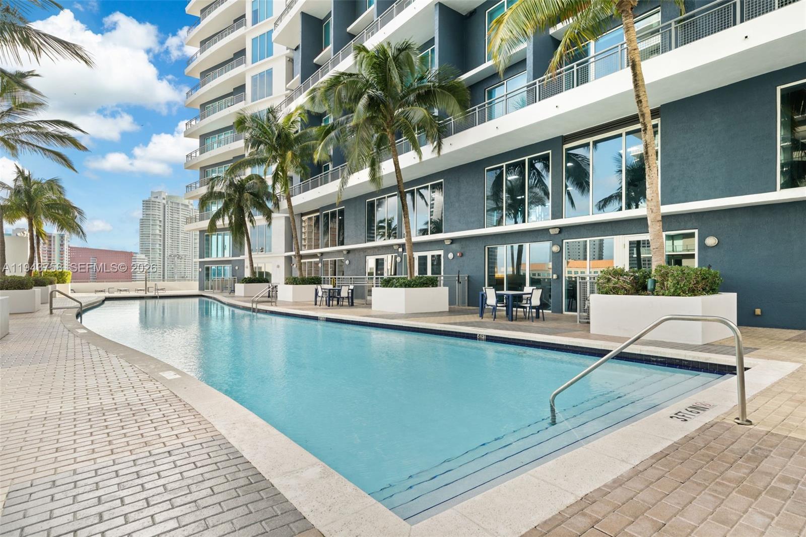 60 Southwest 13th Street, Unit 2812 Miami, FL 33130 - Photo 48 of 66 a view of a swimming pool with a lounge chairs