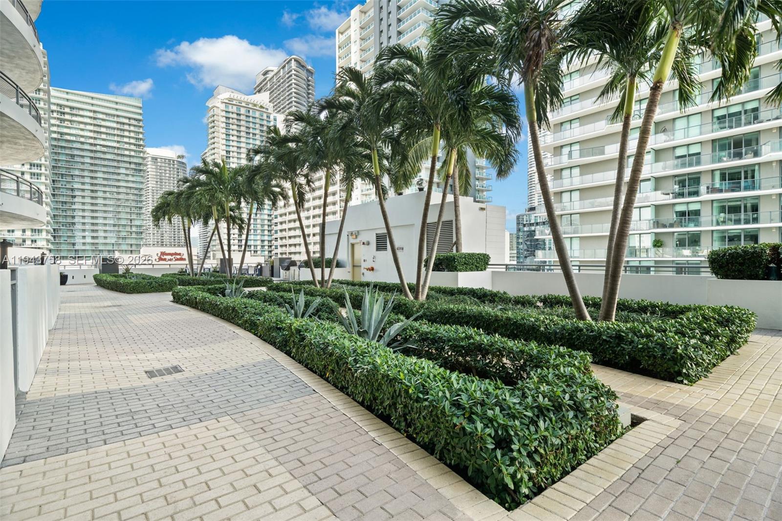 60 Southwest 13th Street, Unit 2812 Miami, FL 33130 - Photo 49 of 66 a front view of a residential apartment building with a yard and potted plants