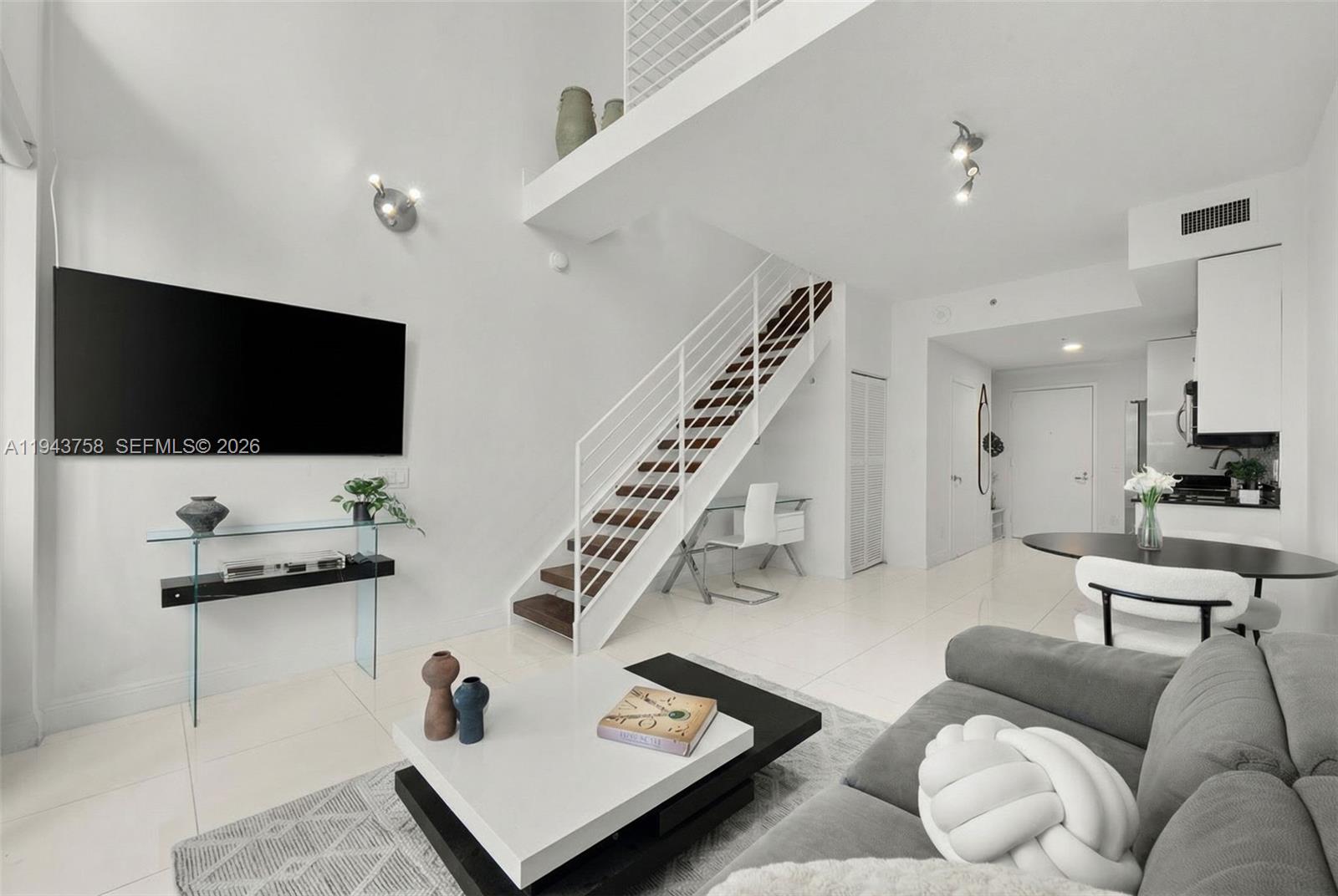 60 Southwest 13th Street, Unit 2812 Miami, FL 33130 - Photo 7 of 66 a living room with furniture and a flat screen tv