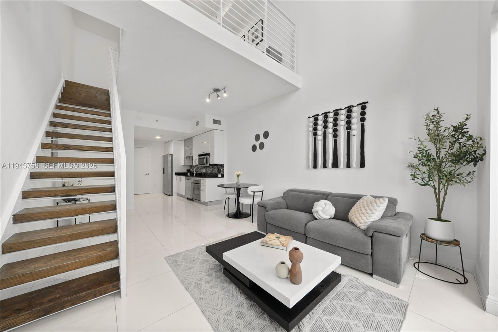 60 Southwest 13th Street, Unit 2812 Miami, FL 33130 - Photo 9 of 66 a living room with furniture and wooden floor