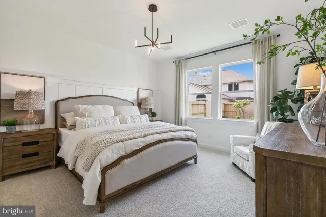a bedroom with bed window and couch