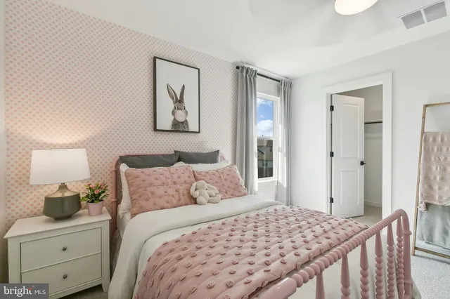 a bedroom with a bed and painting on the wall