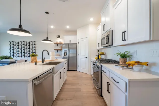 a kitchen with a sink stove and refrigerator