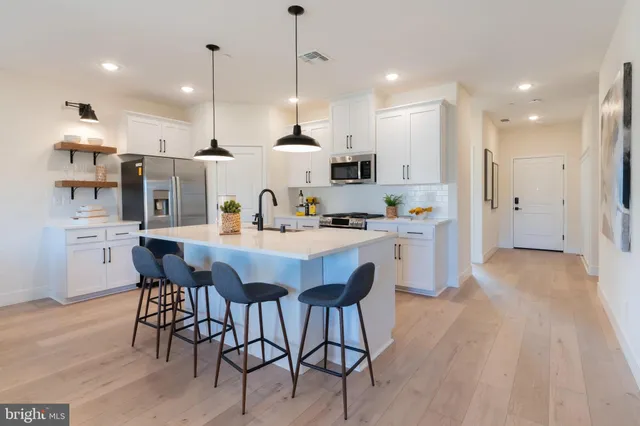 a large kitchen with a table and chairs