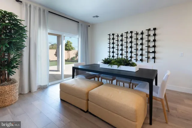 a living room with furniture and potted plant