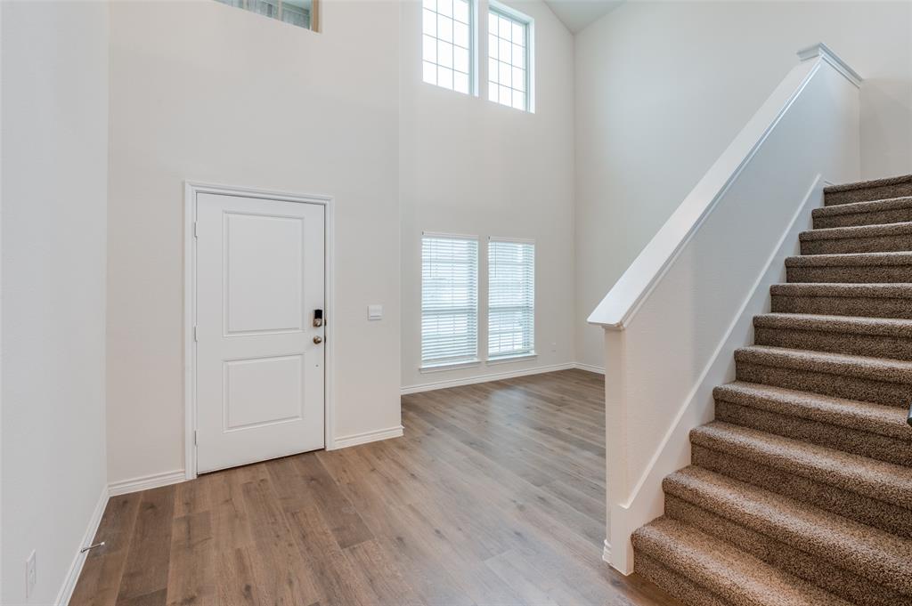 4016 Moss Road Celina, TX 75009 - Photo 1 of 1 Foyer featuring a high ceiling and light wood-type flooring