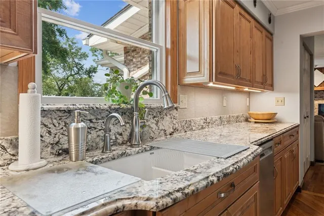 a kitchen with granite countertop a sink and a stove