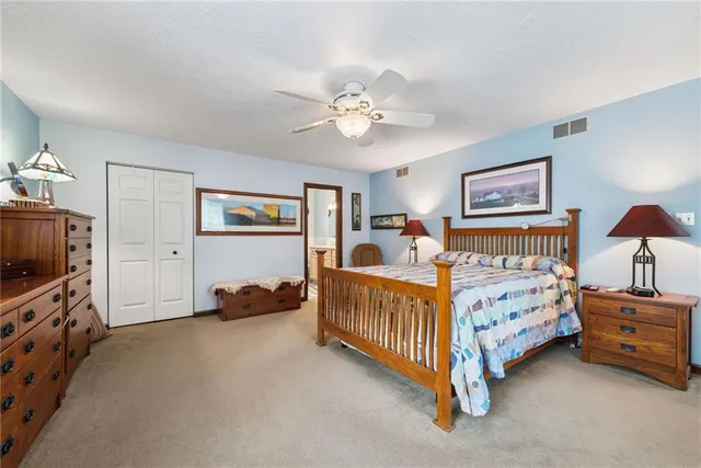 a bedroom with a bed mirror and window
