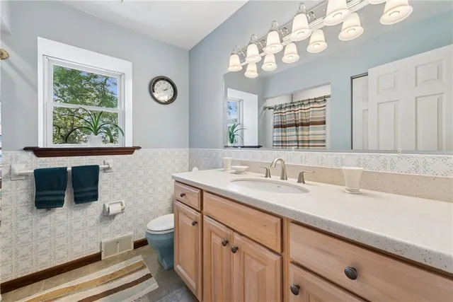 a living room with furniture and a ceiling fan