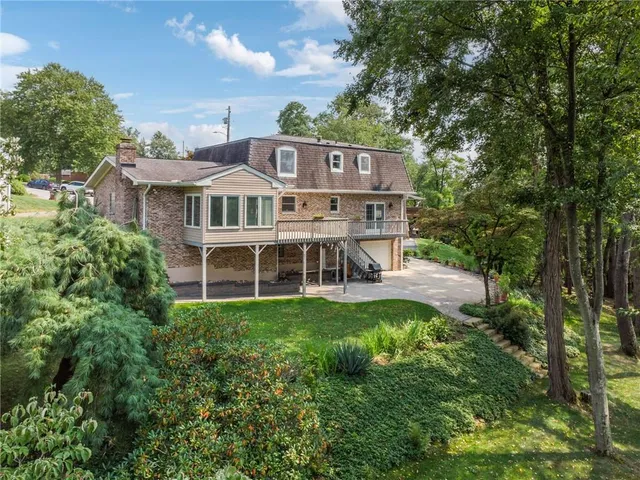a aerial view of a house with a yard table and chairs