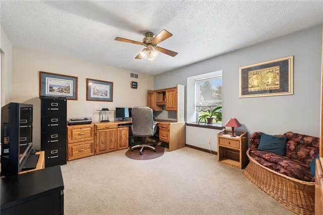 a bathroom with a granite countertop sink a large mirror a toilet and a window