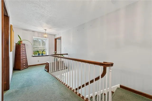 a living room with furniture a rug and kitchen view