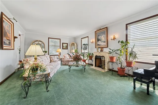 a living room with furniture a fireplace and a window