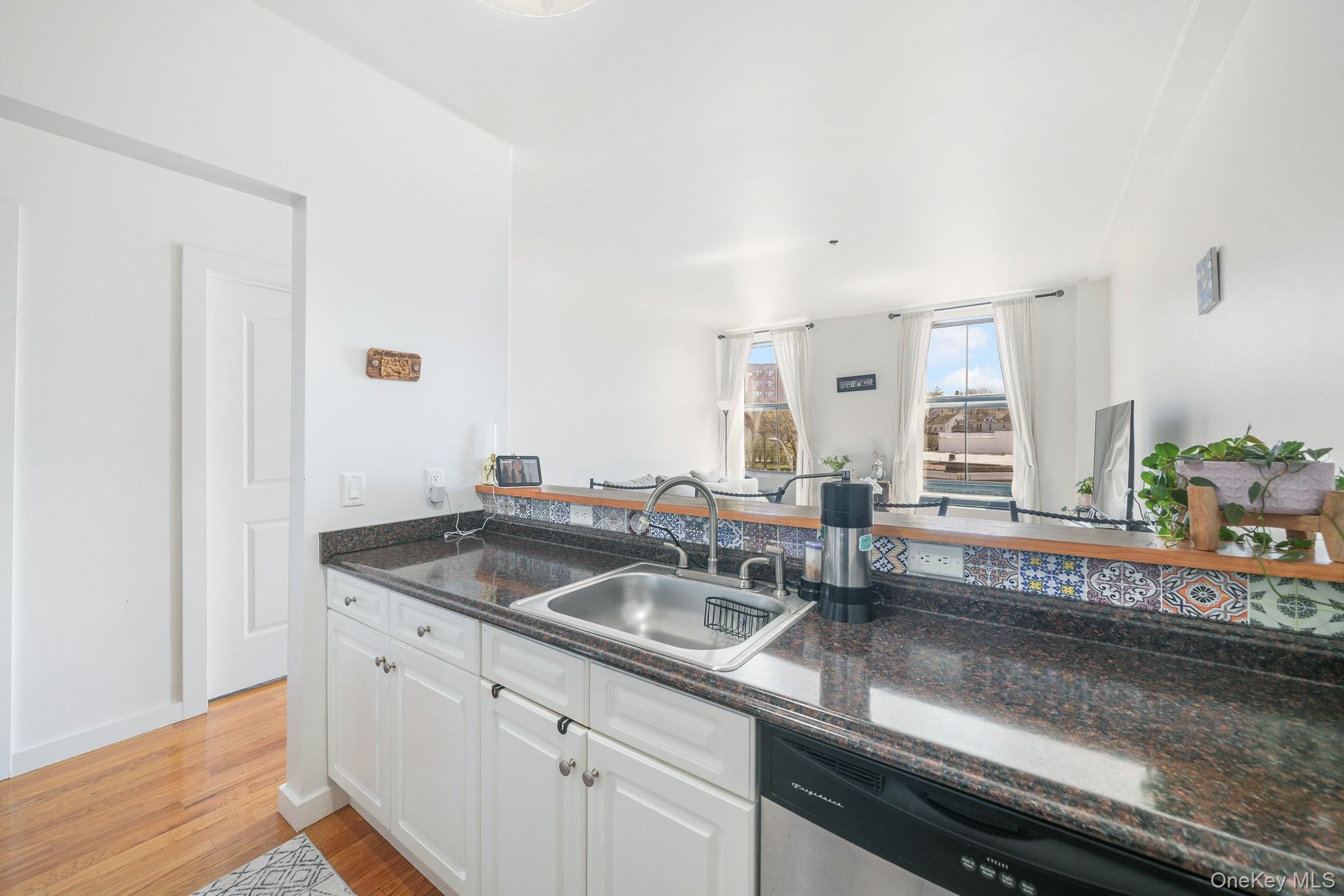 135 Main Street, Unit 302 Ossining, NY 10562 - Photo 6 of 16 a kitchen with granite countertop a sink and a stove
