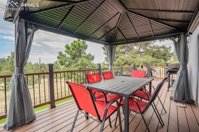 a view of a chairs and table in the wooden deck