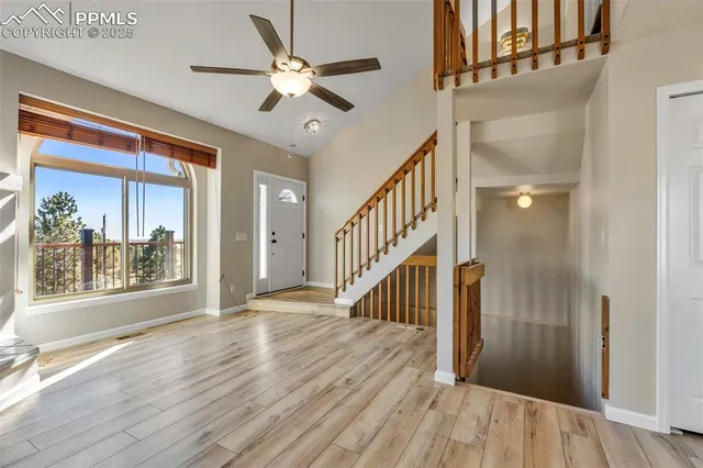 a view of living room with stainless steel appliances granite countertop furniture and fireplace