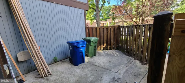 a view of a porch with furniture and floor to ceiling window
