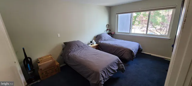 a bedroom with two beds and a window