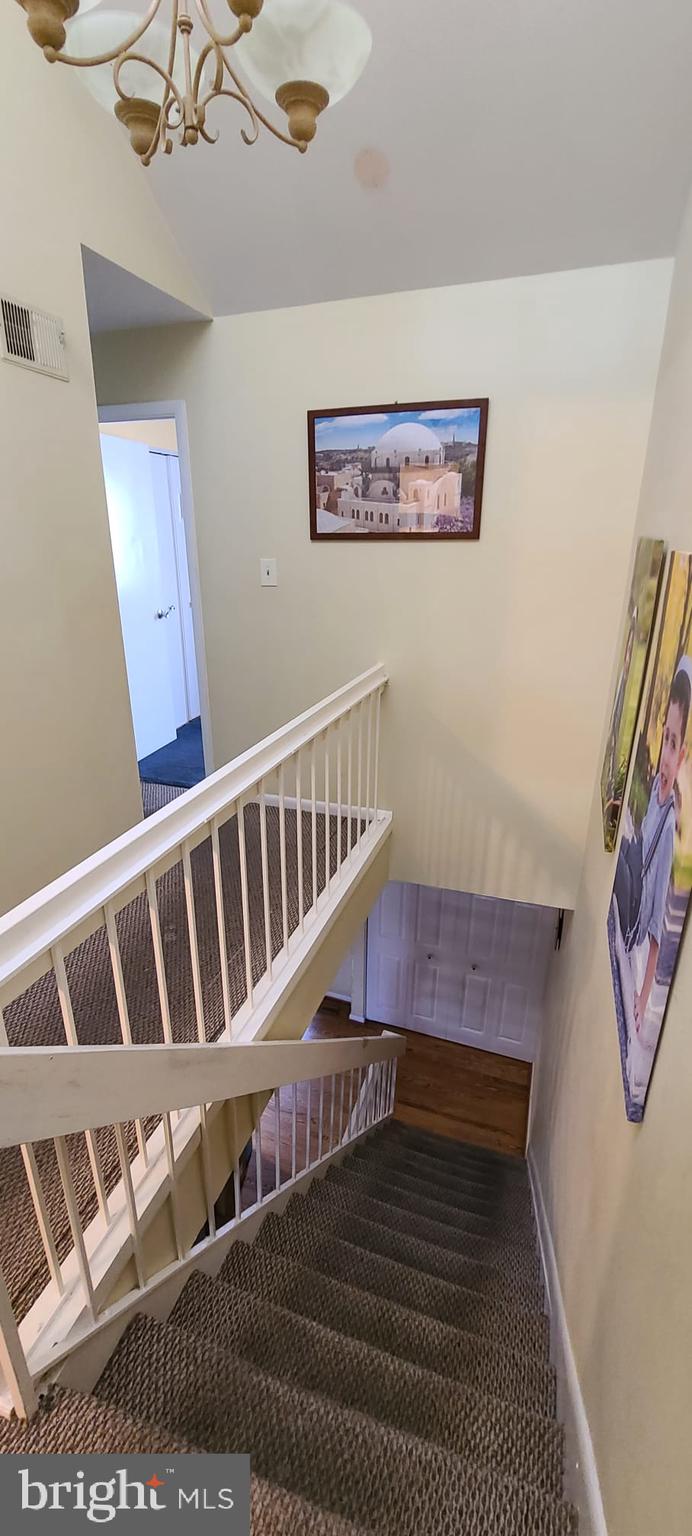 2821 Baneberry Court Baltimore, MD 21209 - Photo 14 of 31 a view of staircase with lots of frames on wall and a window