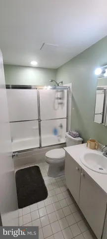 a bathroom with a sink toilet and mirror