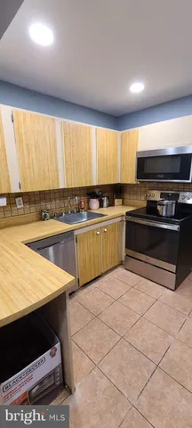 a kitchen with stainless steel appliances granite countertop a sink and cabinets