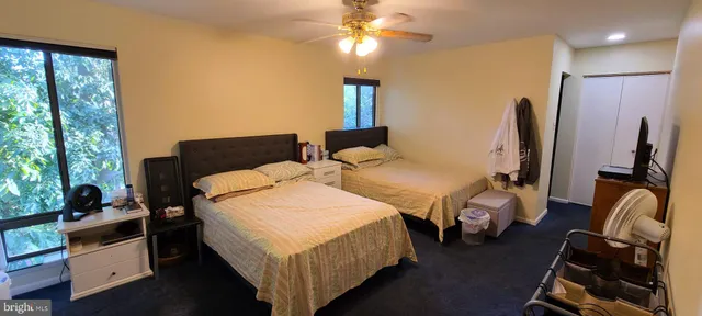 a spacious bedroom with two beds and a chandelier