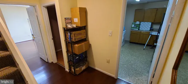 a view of a hallway with wooden floor and entryway