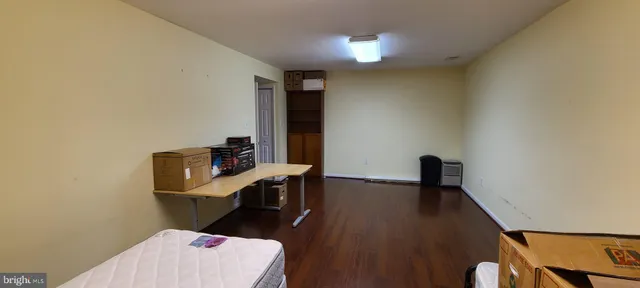 a view of a workspace with furniture and wooden floor