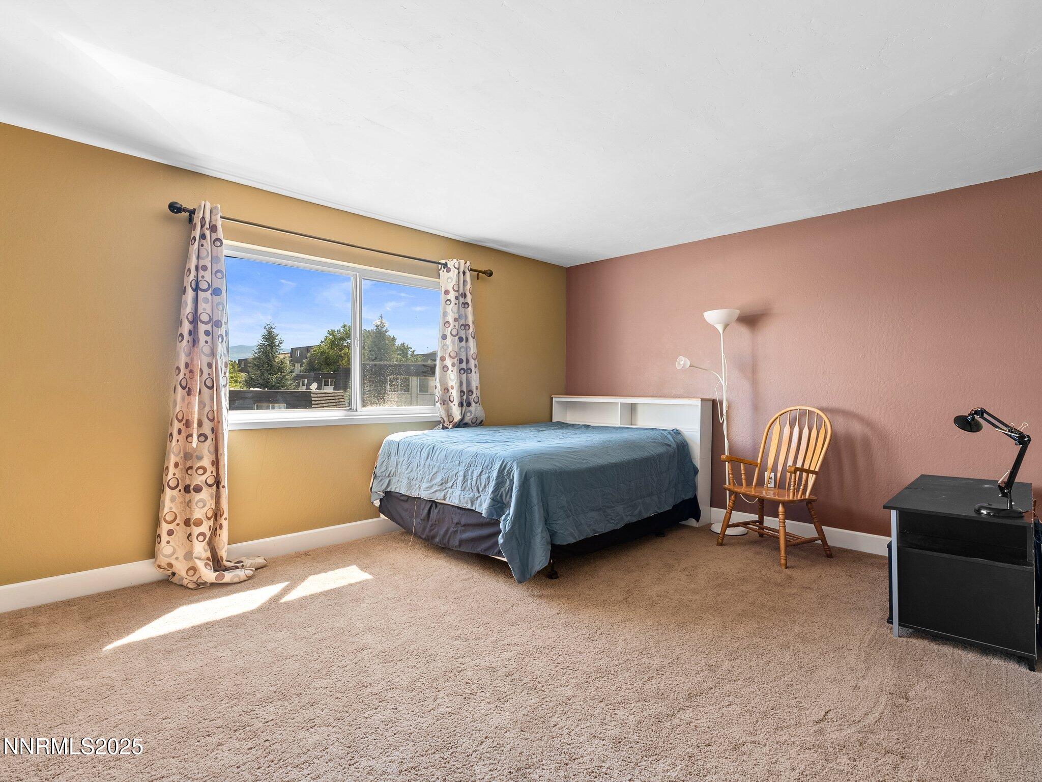 230 Bisset Court, Unit B Reno, NV 89503 - Photo 12 of 14 a bedroom with a bed chair and window