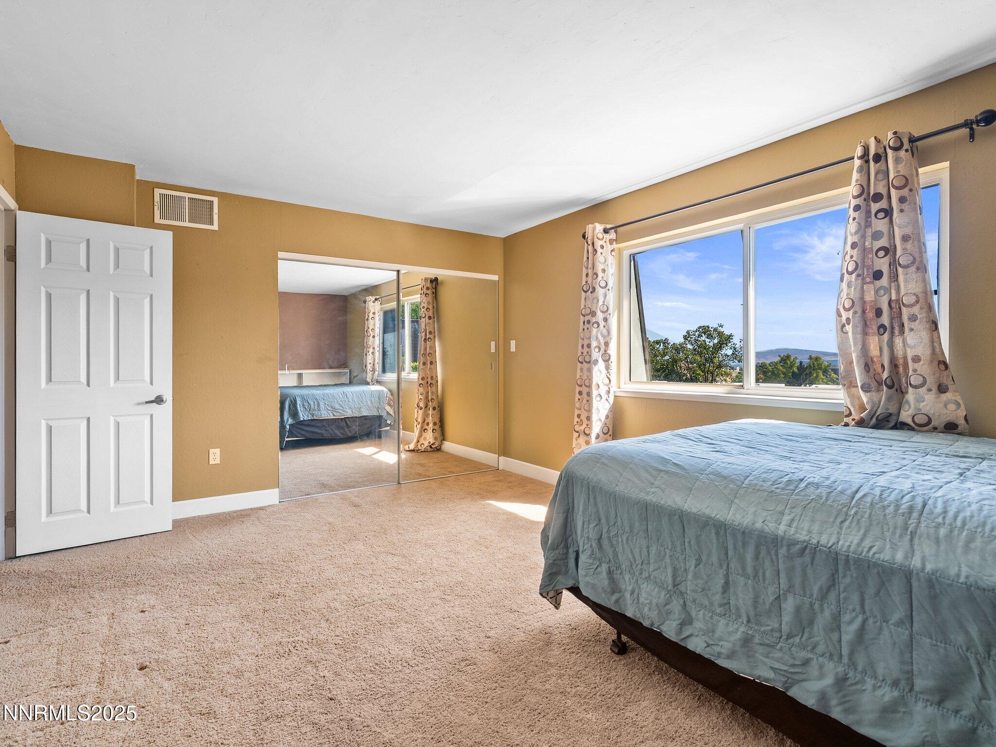 230 Bisset Court, Unit B Reno, NV 89503 - Photo 13 of 14 a bedroom with a bed and a large window