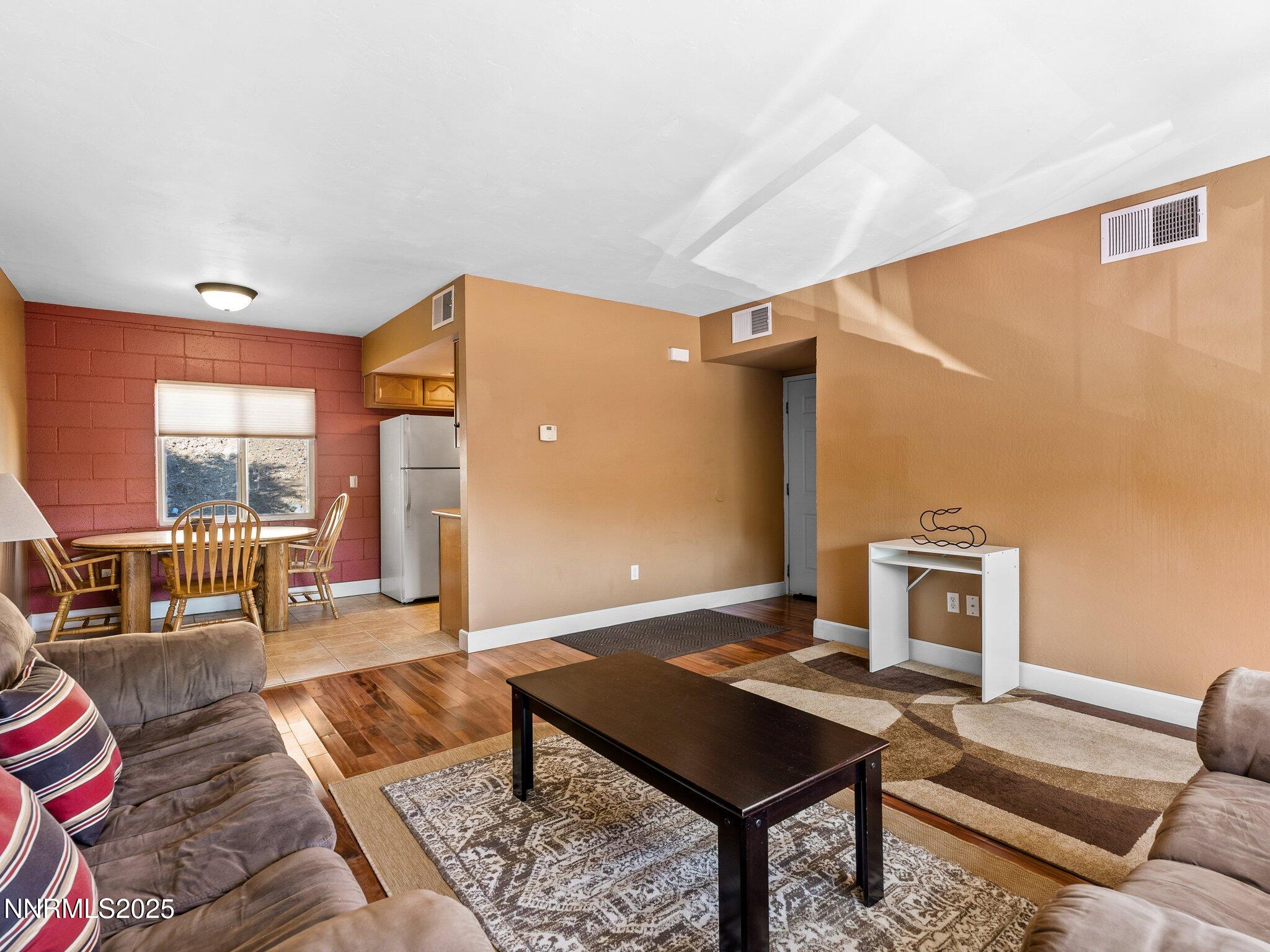 230 Bisset Court, Unit B Reno, NV 89503 - Photo 3 of 14 a living room with furniture and a table