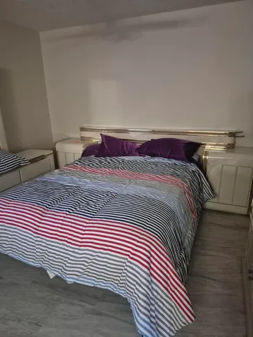 a bedroom with a bed and a mirror