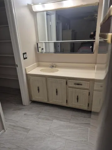 a view of a closet with wooden floor