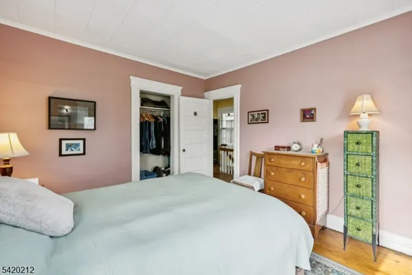a bedroom with a bed and a dresser in it