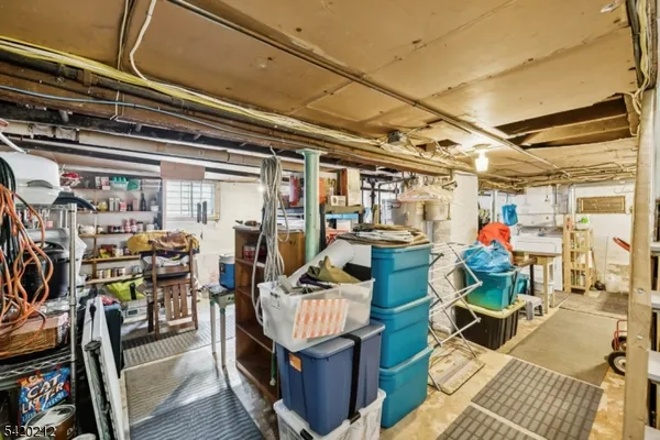 a living room with lots of furniture and clutter