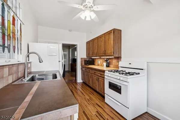 a kitchen with stove a sink and refrigerator