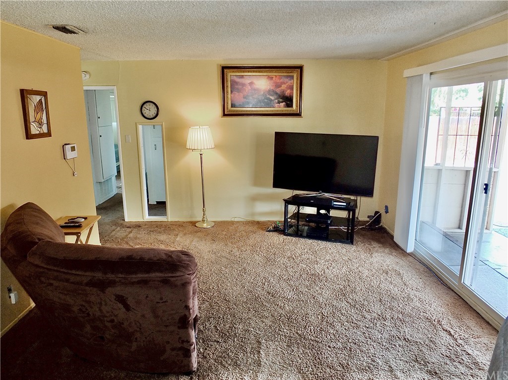 5651 Dean Way Riverside, CA 92504 - Photo 11 of 21 a living room with furniture and a flat screen tv