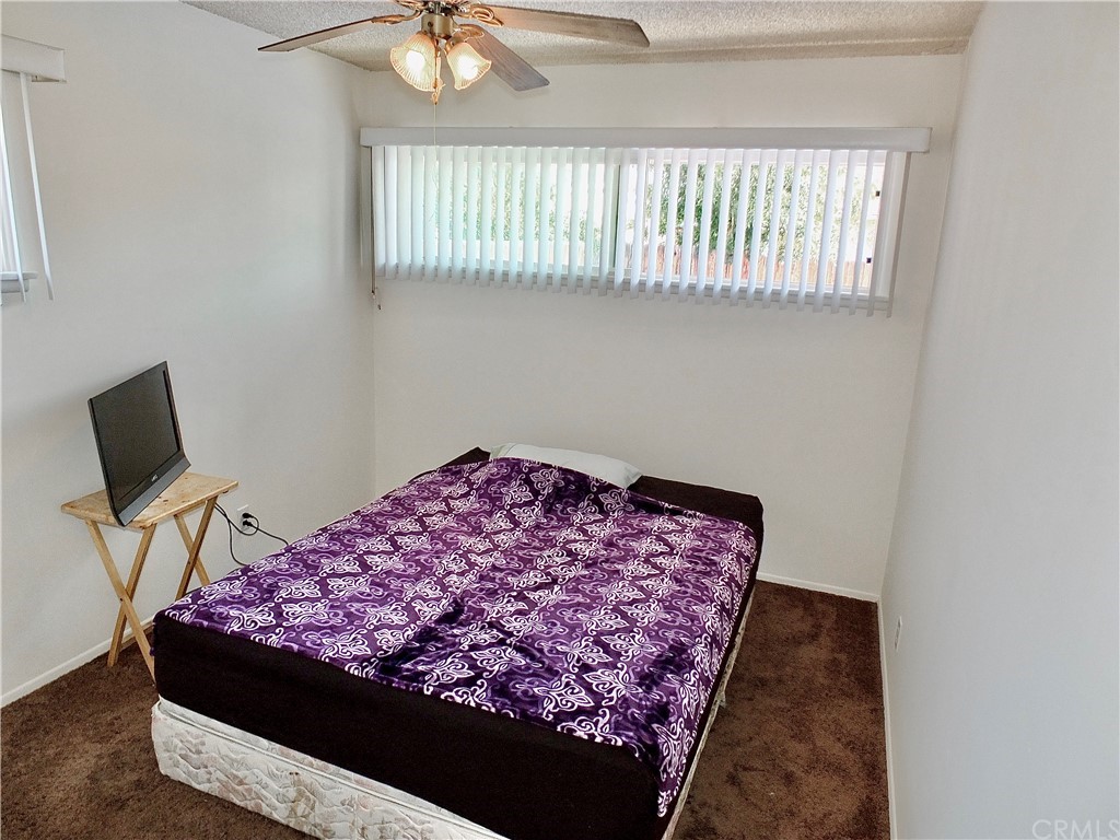 5651 Dean Way Riverside, CA 92504 - Photo 14 of 21 a bedroom with a bed