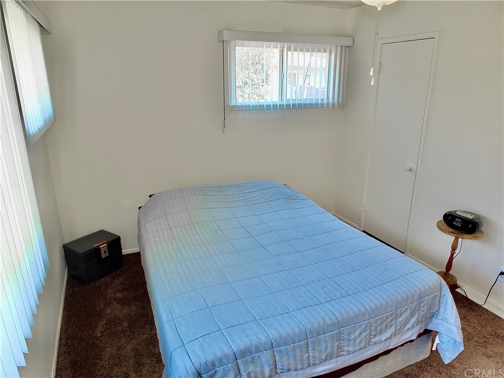 5651 Dean Way Riverside, CA 92504 - Photo 16 of 21 a bed sitting in a bedroom next to a window