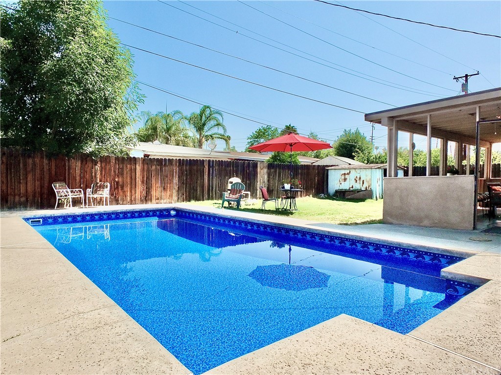5651 Dean Way Riverside, CA 92504 - Photo 19 of 21 a view of swimming pool with chairs and table under an umbrella