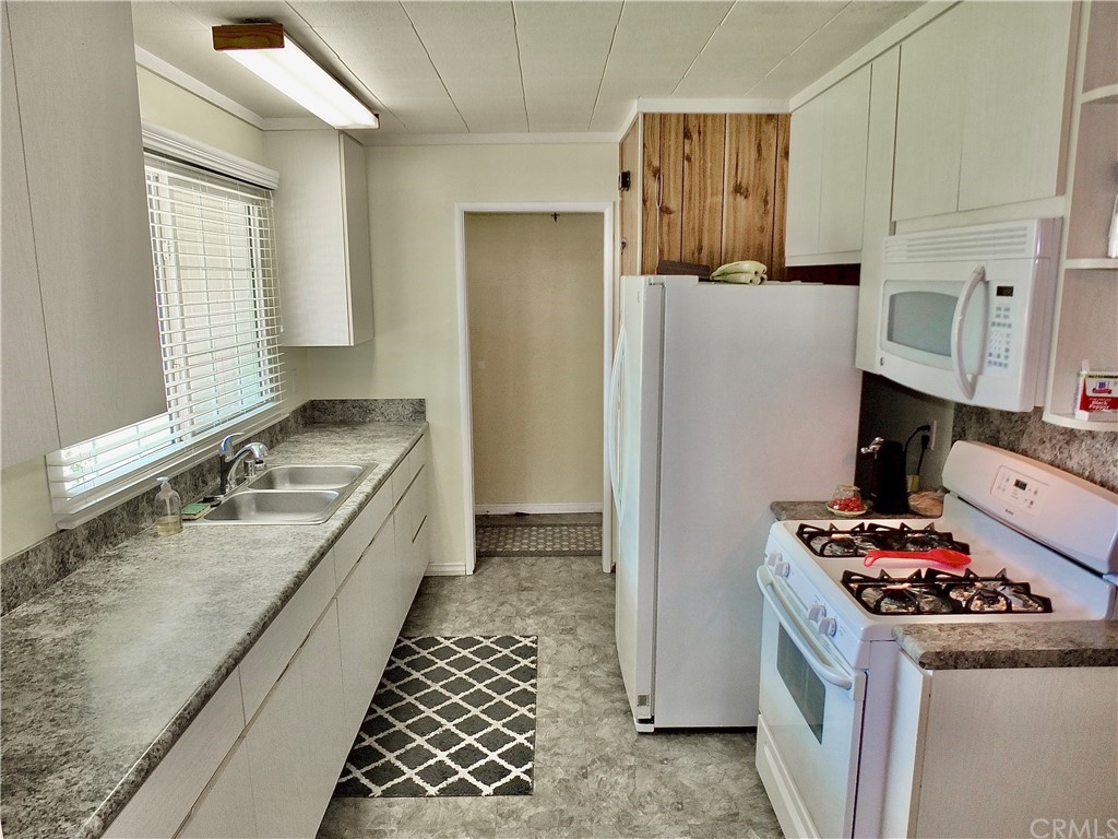 5651 Dean Way Riverside, CA 92504 - Photo 2 of 21 a kitchen with a stove and a refrigerator