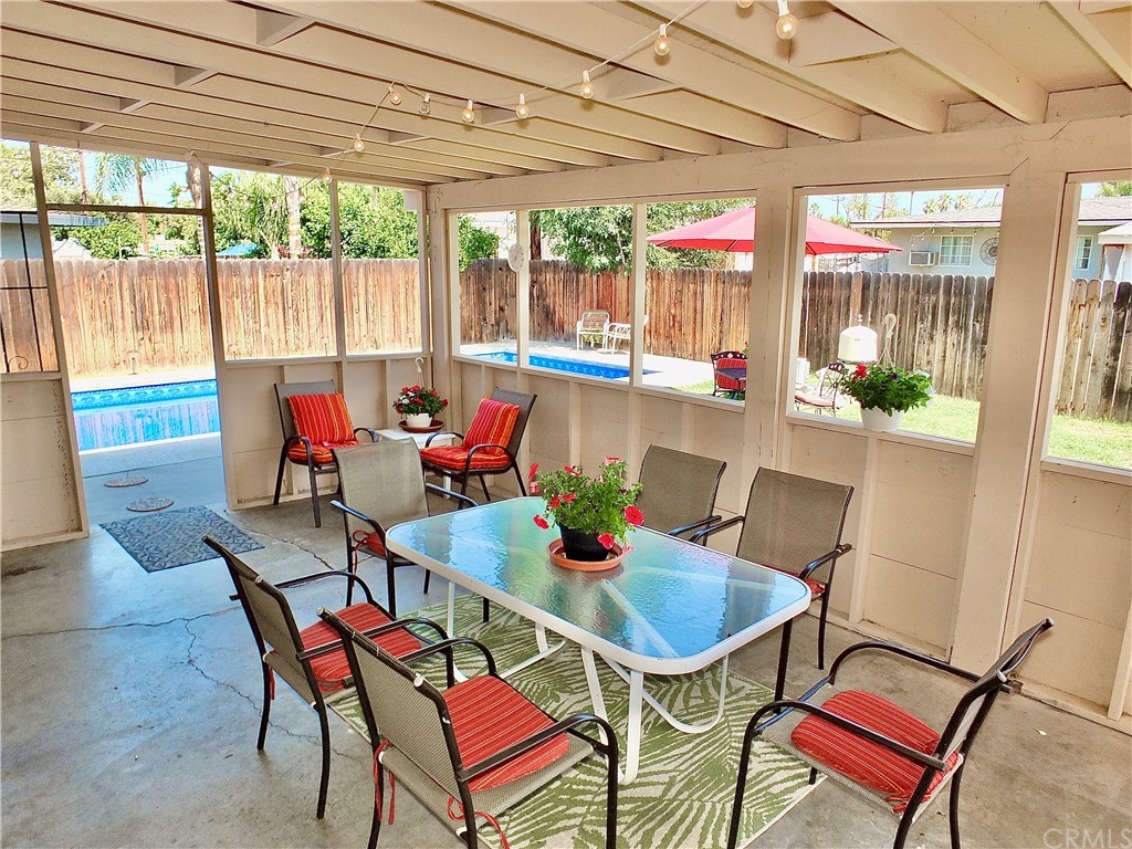 5651 Dean Way Riverside, CA 92504 - Photo 4 of 21 a dining room with furniture a chandelier and wooden floor