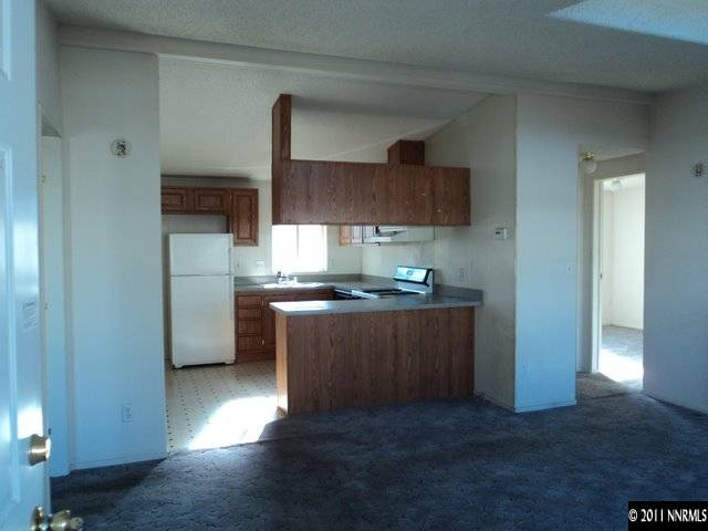 2133 Barberry Way Reno, NV 89512 - Photo 8 of 13 a kitchen with stainless steel appliances granite countertop a refrigerator a sink a stove and oven