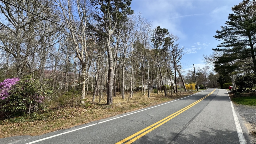53 Brooks Road Harwich, MA 02646 - Photo 3 of 5 a view of a pathway with a yard