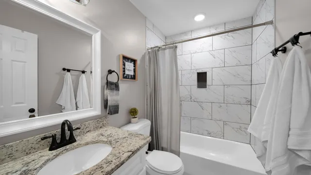 a view of entryway and kitchen with wooden floor