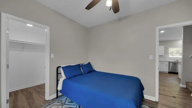 a bedroom with a large bed and a window